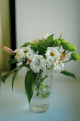 Bouquet of wilted flowers in a vase on a windowsill