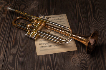 old trumpet on a sheet of music paper