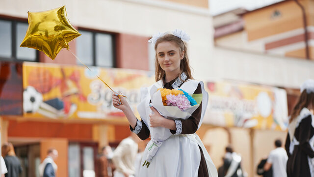 Happy Russian Schoolgirl On The Last Day Of School With Balloons.