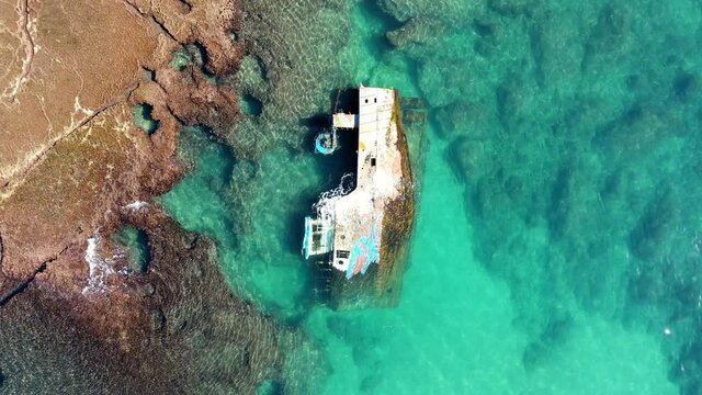 Aerial Top Upward Shot Of Wrecked Ship Sinking In Sea, Bird Flying On Sunny Day - Tel Aviv, Israel