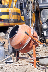 Portable cement mixer on a heavy construction site.