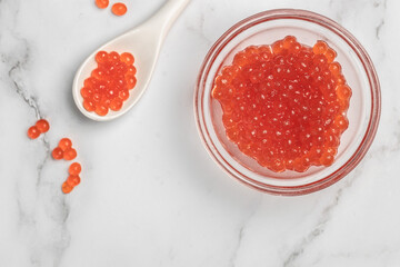 Caviar in glass bowl on whie background. Gourmet food close up, appetizer, selective focus, place for text