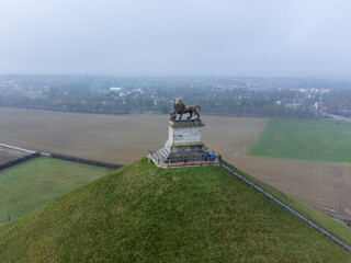 Lion's Mound. Butte Du Lion on the battlefield of Waterloo where Napoleon was defeated. Drone aerial view on a cloudy winter day.