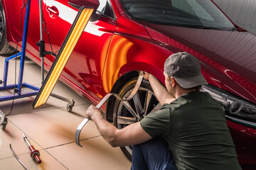 Removing dents on a car body without painting. PDR. - obrazy, fototapety, plakaty