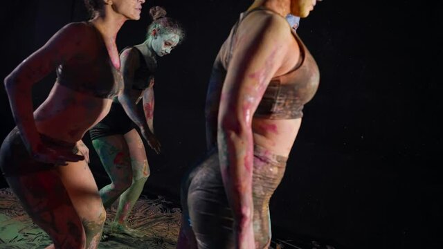talented modern ballerinas are dancing contemporary choreo in art studio, ladies stained with dyes