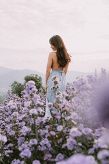 Portrait of thai young woman enjoying in blooming flower field