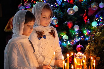 The girls in the temple is holding a candle. Christmas