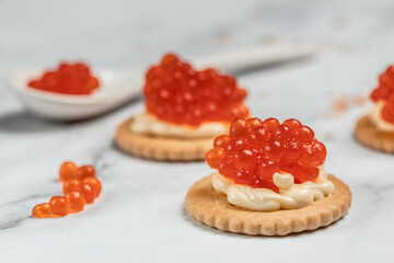 Canape portion cracker, butter and red caviar. Delicious red caviar appetizer, banner, menu, recipe. selective focus, place for text