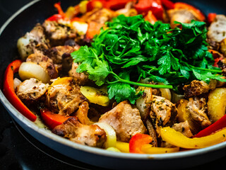 Chicken nuggets with vegetables in frying pan

