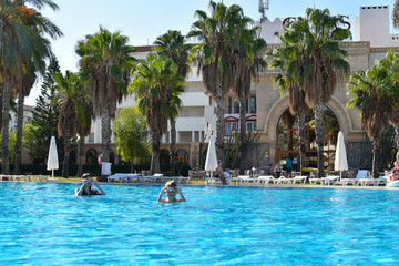 Fototapeta na wymiar large blue pool in a luxury hotel by sea. swimming in the outdoor pool in tropics