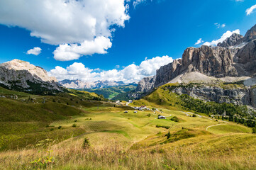 Aerial view of Gardena Pass and Sass dla Luesa dolomite tower, Trentino Alto Adige, Italy. Alpine meadows and Passo Gardena.