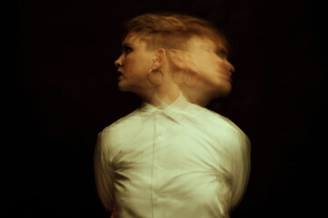crazy psychopathic girl with mental disorders in a straitjacket on a dark background