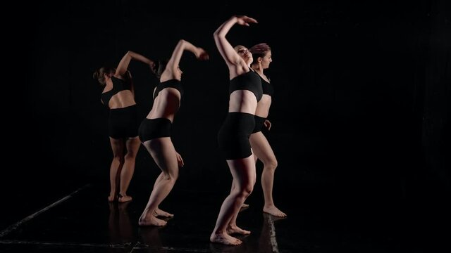 modern dance art, four women are dancing in darkness, contemporary choreography