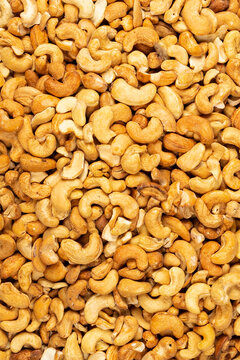 Peeled fresh golden cashew nuts in bulk top view