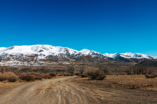 High cliffs in the mountains with snow on the peaks in Altai