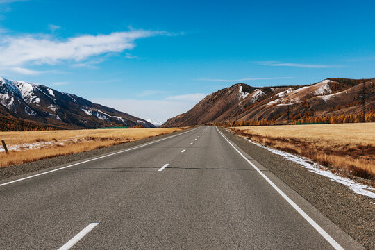 A road in the mountains with beautiful landscapes and views of rocks and peaks in Altai