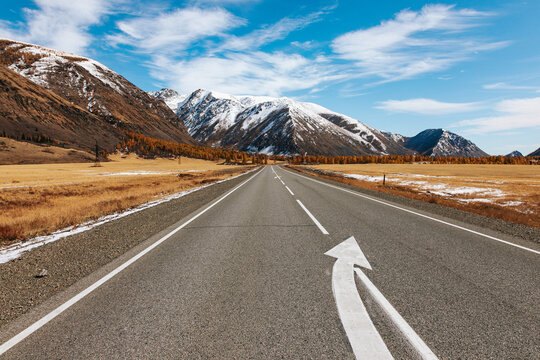 A road in the mountains with beautiful landscapes and views of rocks and peaks in Altai
