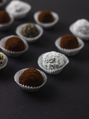 Energy protein balls with healthy ingredients on dark background. Home made with dates, peanut butter, flax and chia seeds, oats, almond and chocolate drops