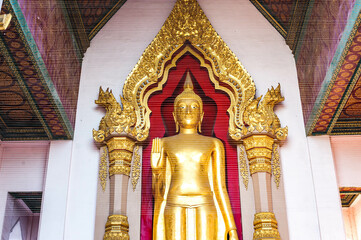 The standing gold buddha statue at Phra Pathom Chedi the landmark of Nakorn Pathom province, Thailand