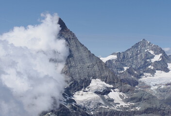 Fototapeta na wymiar View to Matterhorn, Cervino mountain in clouds in Switzerland