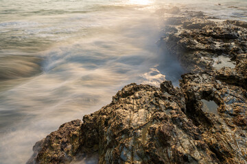 sea and rocks in sunset in long exposure