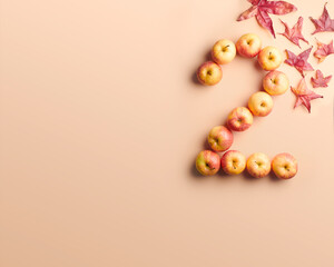 The number 2 shaped by apples and surrounded by colorful autumn leaves on a peach background. 