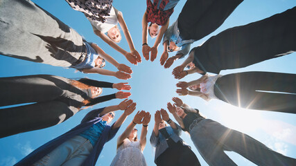 Eleven girls make a circle from their palms.
