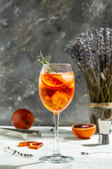 spritz tropical aperol cocktail with with bloody oranges, red bitter, dry white wine, soda, zest...