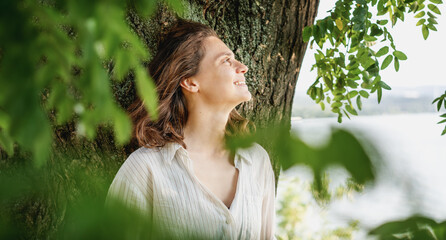 Beautiful happy young woman relaxing enjoying nature in the garden