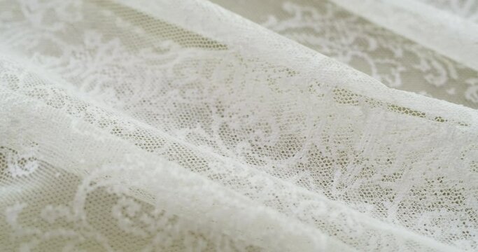 White lace close-up. Sewing a wedding dress. Light guipure. Handmade tailoring, professional clothing concept. Abstract background. 