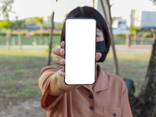 Mobile phone blank, simulated white screen. Mobile woman texting using mobile phone in park for working people. Contact marketing business. Technology.