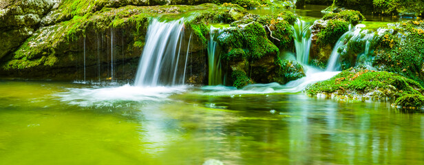 closeup small waterfall on mountain river, summer outdoor travel scene © Yuriy Kulik