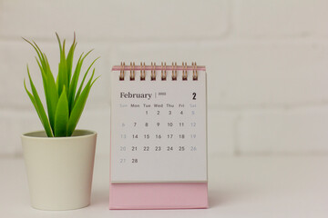 Desktop calendar for February 2022 on a light background.