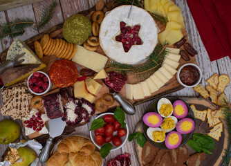 Elegant  Christmas cheese and cracikers board with a wide range of cheeses, finger foods on wooden board