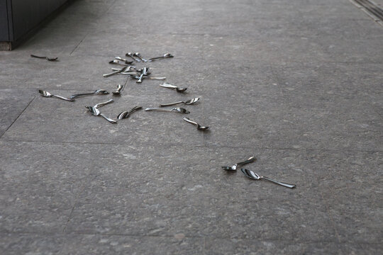 spoons scattered on the sidewalk