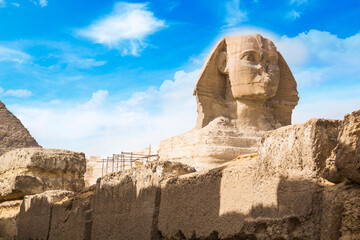 Great Sphinx against the background of the pyramids of the pharaohs Cheops, Khafren, and Mikerin in Giza, Egypt