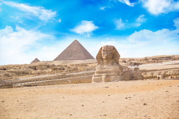 Great Sphinx against the background of the pyramids of the pharaohs Cheops, Khafren, and Mikerin in...
