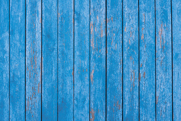 Fototapeta na wymiar wooden wall with vertical planks. old blue paint. background for designer