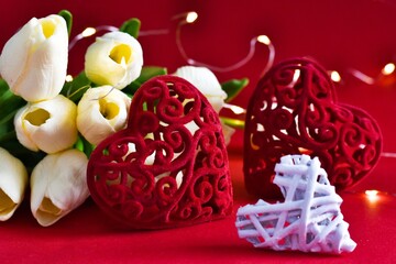 Banner with hearts, bouquet of tulips and defocused lights on red background. Valentines day card. Closeup. Selective focus. Valentine's day concept. Festive background for valentine's day 