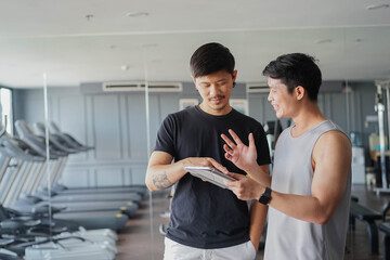 close up group of asian professional trainer explain and talk about program to member during rest after workout for health lifestyle concept