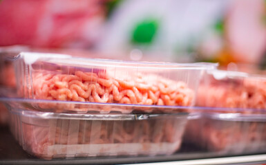 Meat products put up for sale in a supermarket commercial fridge