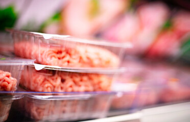 Meat products put up for sale in a supermarket commercial fridge