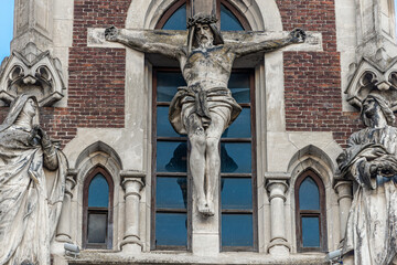 Obraz premium LVIV, UKRAINE - January, 2021: Exterior of the Greek Catholic Church of Sts. Olha and Elizabeth. Statue of Jesus Christ crucifixion on facade.