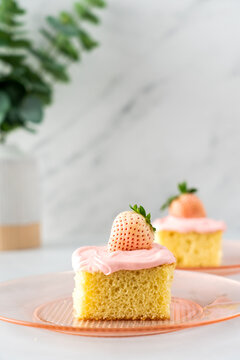 Yellow cake with vanilla frosting and white strawberry
