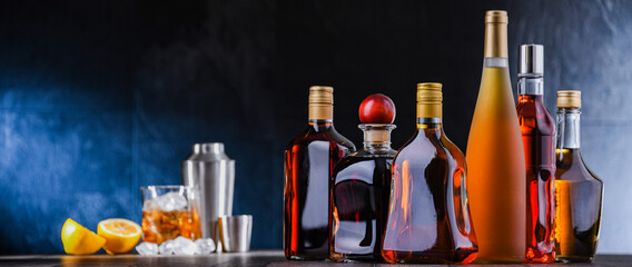 Bottles of assorted alcoholic beverages and bartender