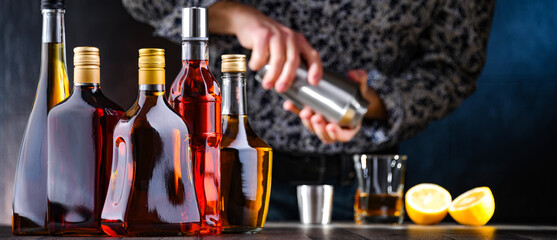 Bottles of assorted alcoholic beverages and bartender