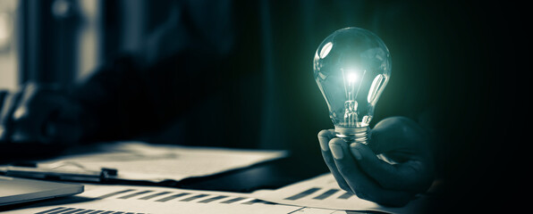 Close up hand choose light bulb or lamp with bright for human resources or leadership and creativity thinking idea motivation or vision and knowledge learning. © Jintana