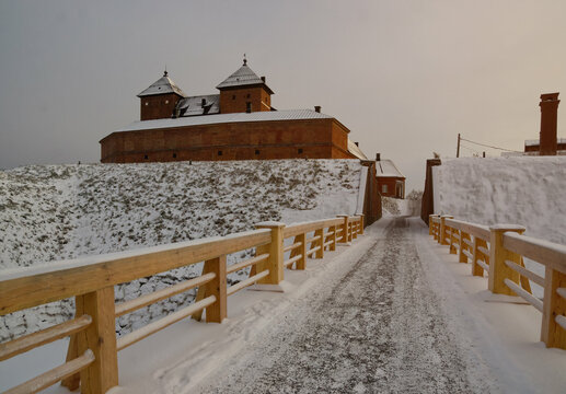 Wooden bridge in winter to the historical mediaval castle of Häme (Hämeen linna) near Vanaja lake in Finland. 