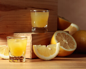 Traditional homemade lemon liqueur limoncello and fresh citrus.