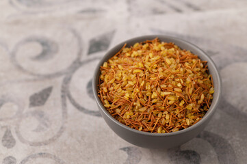 Bulgur with vermicelli, garnish, on a gray background with a pattern, close up